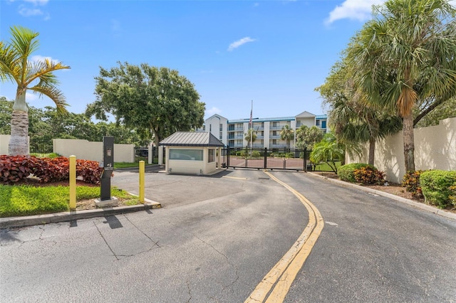2424 W Tampa Bay Blvd Unit G204, Tampa, FL 33607 - view of asphalt street with a gate, curbs, and a gated entry