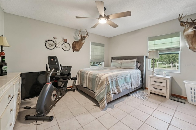 10614 Hudson Ave, Hudson, FL 34669 - bedroom with a textured ceiling, a ceiling fan, and light tile patterned floors