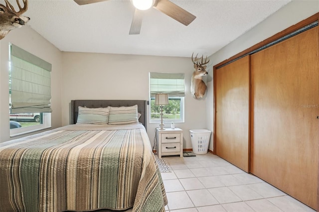 10614 Hudson Ave, Hudson, FL 34669 - bedroom featuring light tile patterned floors, a closet, and ceiling fan