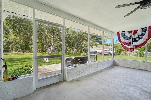 10614 Hudson Ave, Hudson, FL 34669 - unfurnished sunroom featuring ceiling fan, view of wooded area, and healthy amount of natural light