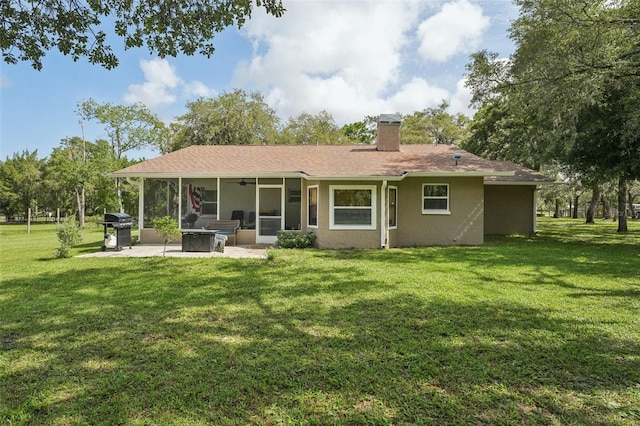 10614 Hudson Ave, Hudson, FL 34669 - rear view of house featuring a patio area, a chimney, a yard, and a sunroom