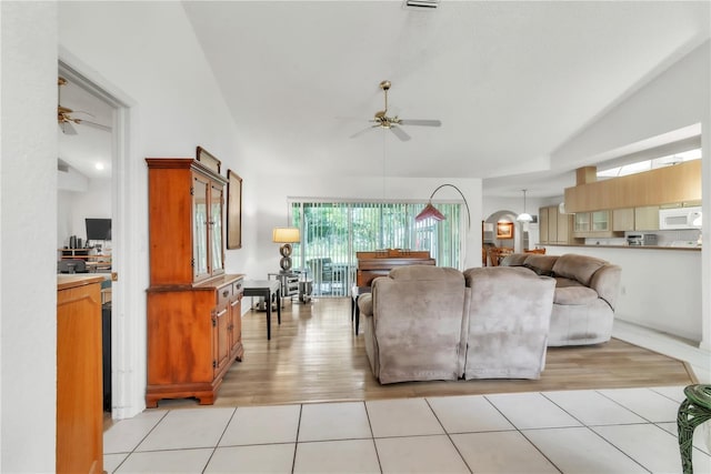 22946 Brownwood Ct, Land O Lakes, FL 34639 - living room with a ceiling fan, light wood-style flooring, and high vaulted ceiling
