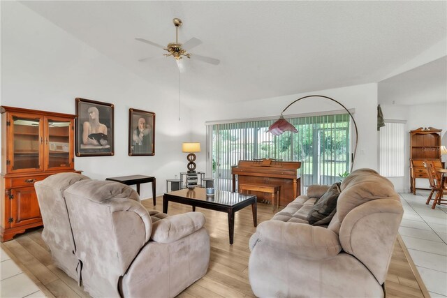 22946 Brownwood Ct, Land O Lakes, FL 34639 - living area with ceiling fan, vaulted ceiling, and light wood-style floors