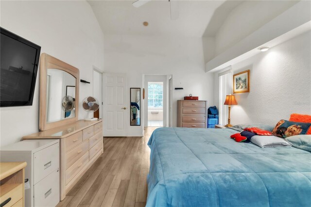 22946 Brownwood Ct, Land O Lakes, FL 34639 - bedroom featuring light wood finished floors, a towering ceiling, connected bathroom, and a ceiling fan
