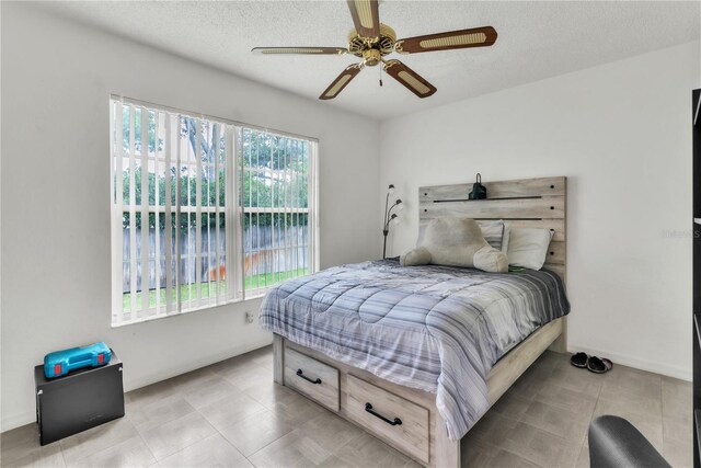 22946 Brownwood Ct, Land O Lakes, FL 34639 - bedroom with a ceiling fan and a textured ceiling