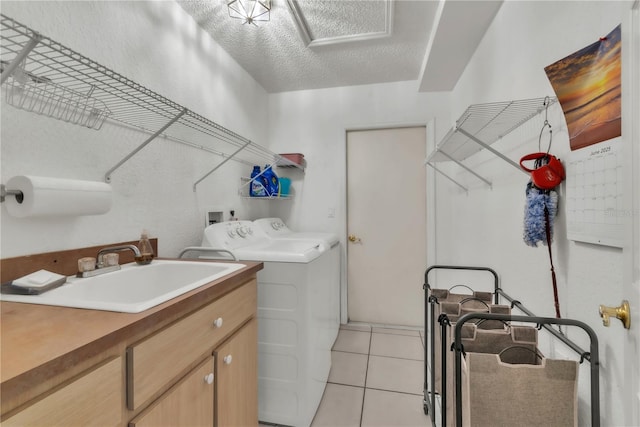 22946 Brownwood Ct, Land O Lakes, FL 34639 - washroom with cabinet space, washing machine and clothes dryer, light tile patterned flooring, and a textured ceiling