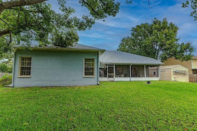 22946 Brownwood Ct, Land O Lakes, FL 34639 - back of house with a sunroom, a lawn, and stucco siding