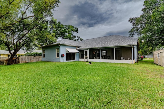 22946 Brownwood Ct, Land O Lakes, FL 34639 - back of house with a sunroom, stucco siding, and a shingled roof