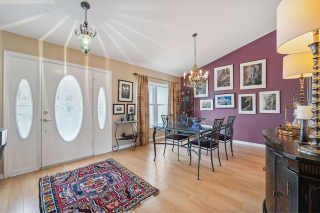 13238 Asbury St, Spring Hill, FL 34609 - entrance foyer featuring a chandelier, lofted ceiling, light wood-style flooring, and baseboards
