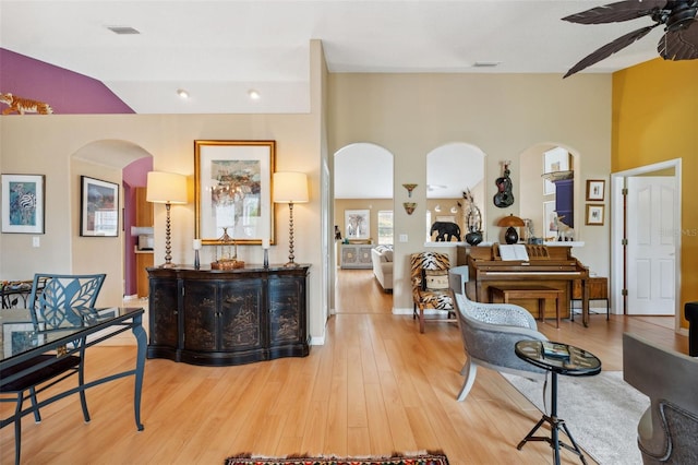 13238 Asbury St, Spring Hill, FL 34609 - living area featuring arched walkways, a ceiling fan, light wood-type flooring, and high vaulted ceiling