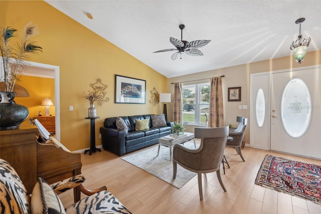 13238 Asbury St, Spring Hill, FL 34609 - living room featuring lofted ceiling, a ceiling fan, light wood finished floors, and a textured ceiling