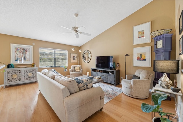 13238 Asbury St, Spring Hill, FL 34609 - living room featuring vaulted ceiling, light wood-type flooring, ceiling fan, and a textured ceiling