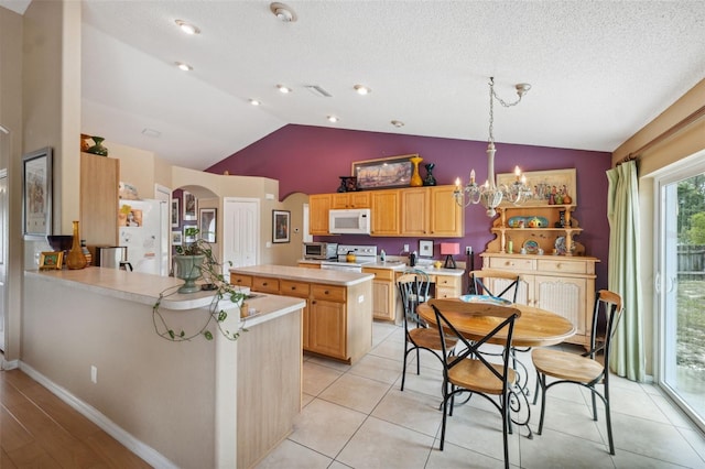 13238 Asbury St, Spring Hill, FL 34609 - kitchen featuring white appliances, arched walkways, vaulted ceiling, light countertops, and light brown cabinetry