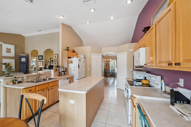 13238 Asbury St, Spring Hill, FL 34609 - kitchen with white appliances, a sink, a center island, arched walkways, and high vaulted ceiling