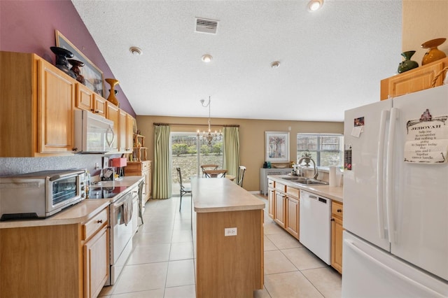 13238 Asbury St, Spring Hill, FL 34609 - kitchen with white appliances, a sink, a textured ceiling, light countertops, and healthy amount of natural light