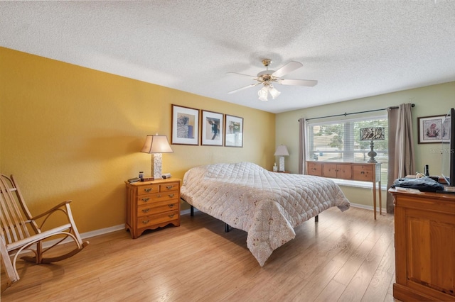 13238 Asbury St, Spring Hill, FL 34609 - bedroom featuring light wood-style floors, baseboards, a textured ceiling, and ceiling fan