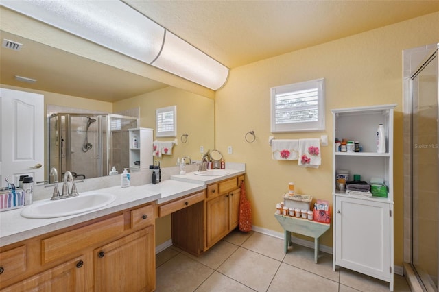 13238 Asbury St, Spring Hill, FL 34609 - full bathroom with double vanity, a stall shower, tile patterned flooring, and baseboards