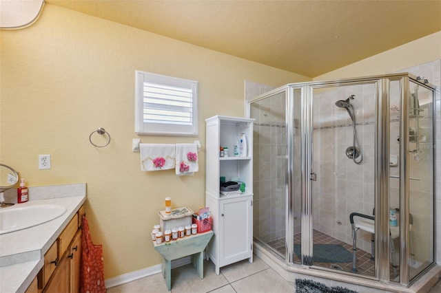 13238 Asbury St, Spring Hill, FL 34609 - bathroom featuring a shower stall, vanity, tile patterned flooring, vaulted ceiling, and baseboards