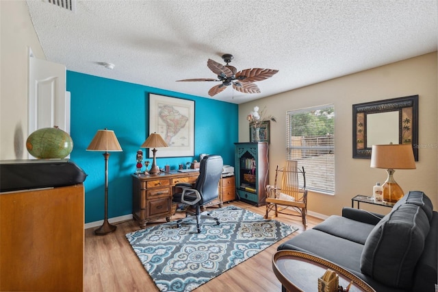 13238 Asbury St, Spring Hill, FL 34609 - office with a textured ceiling, light wood-style floors, ceiling fan, and baseboards