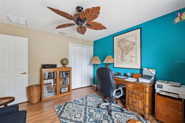 13238 Asbury St, Spring Hill, FL 34609 - home office with ceiling fan, wood finished floors, and a textured ceiling