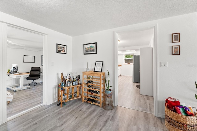 4922 Bola St, New Port Richey, FL 34652 - corridor featuring wood finished floors, an office area, and a textured ceiling