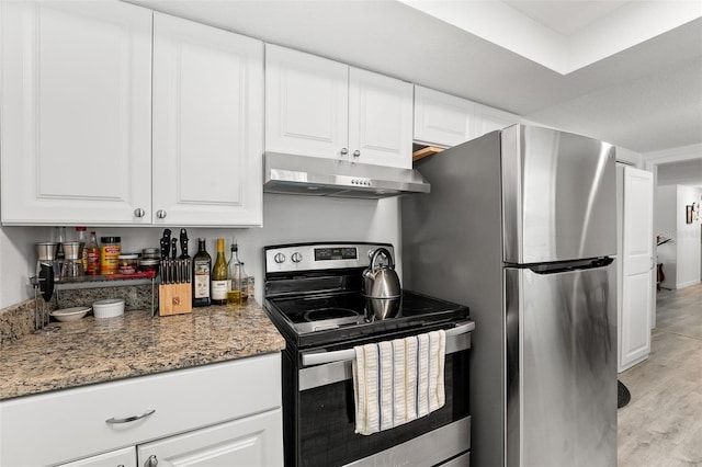 4922 Bola St, New Port Richey, FL 34652 - kitchen with appliances with stainless steel finishes, under cabinet range hood, light wood finished floors, and white cabinetry