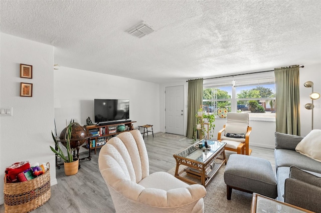 4922 Bola St, New Port Richey, FL 34652 - living room featuring light wood finished floors and a textured ceiling