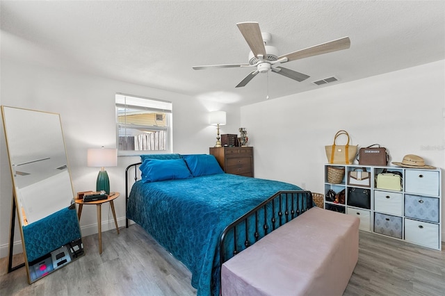 4922 Bola St, New Port Richey, FL 34652 - bedroom featuring wood finished floors, ceiling fan, and a textured ceiling