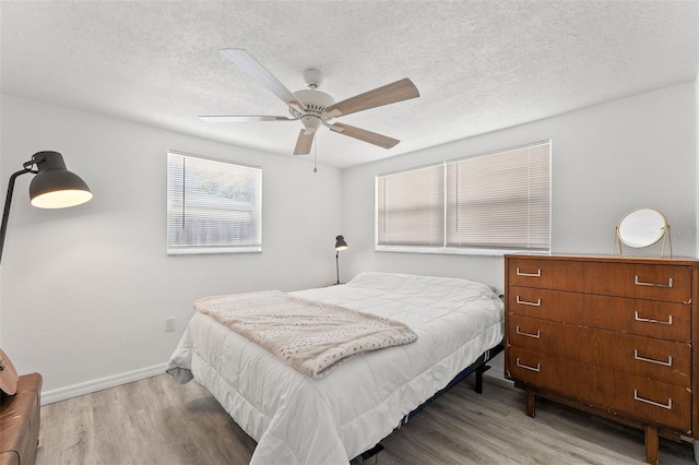4922 Bola St, New Port Richey, FL 34652 - bedroom featuring wood finished floors, ceiling fan, and a textured ceiling