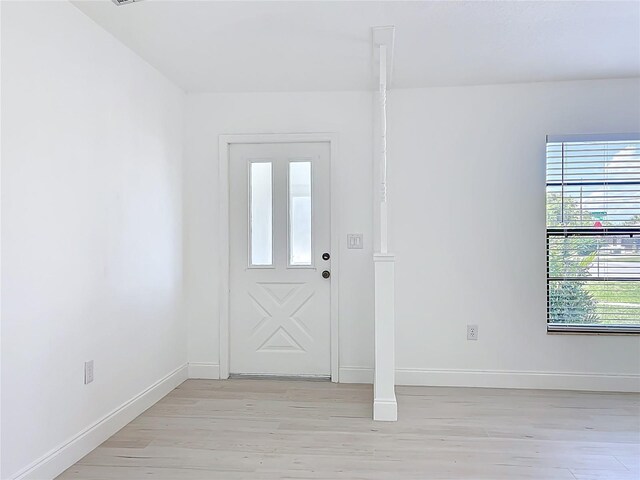 21426 Quesada Ave, Port Charlotte, FL 33952 - foyer entrance with light wood-style floors and baseboards