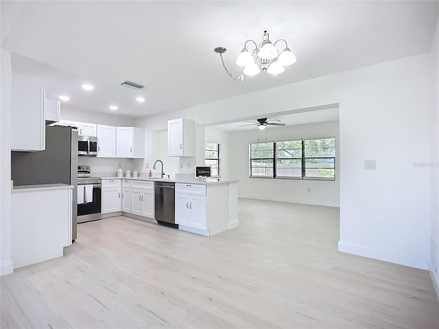 21426 Quesada Ave, Port Charlotte, FL 33952 - kitchen with appliances with stainless steel finishes, a chandelier, light wood-type flooring, white cabinets, and recessed lighting