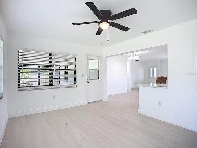 21426 Quesada Ave, Port Charlotte, FL 33952 - unfurnished room featuring light wood-type flooring, a ceiling fan, and a chandelier