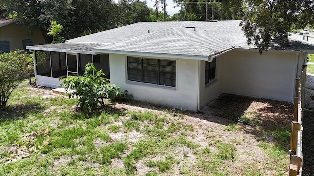 21426 Quesada Ave, Port Charlotte, FL 33952 - back of property with stucco siding, a sunroom, and a shingled roof