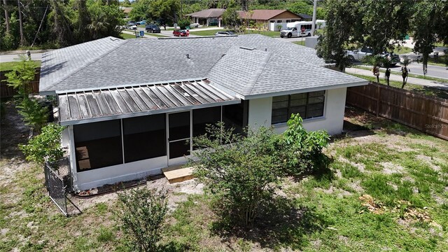 21426 Quesada Ave, Port Charlotte, FL 33952 - rear view of property with a sunroom, roof with shingles, a residential view, and stucco siding