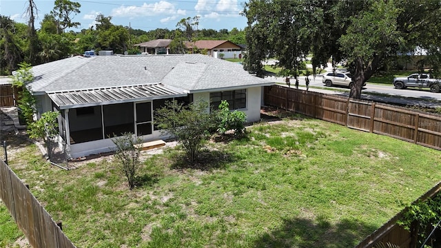 21426 Quesada Ave, Port Charlotte, FL 33952 - rear view of property featuring a sunroom, a fenced backyard, and roof with shingles