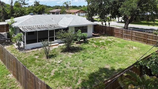 21426 Quesada Ave, Port Charlotte, FL 33952 - rear view of property with a sunroom, a fenced backyard, and a shingled roof