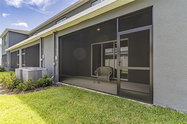 2801 Midnight Pearl Dr, Sarasota, FL 34240 - entrance to property with central AC unit, stucco siding, and a yard