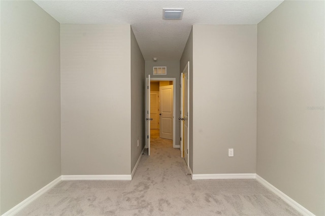 2801 Midnight Pearl Dr, Sarasota, FL 34240 - empty room with light colored carpet, baseboards, and a textured ceiling
