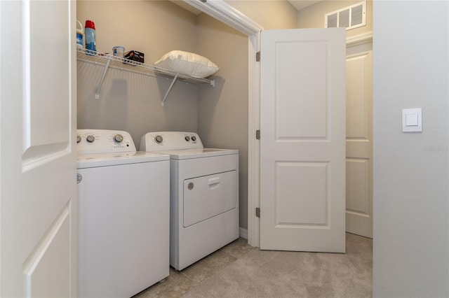 2801 Midnight Pearl Dr, Sarasota, FL 34240 - laundry area with washing machine and dryer and light tile patterned flooring