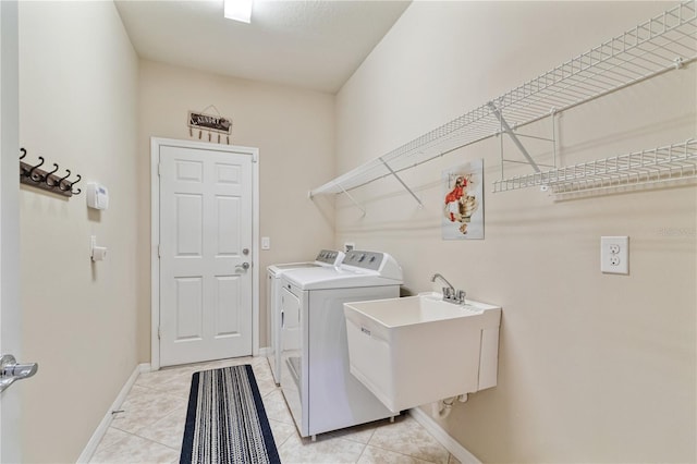 19418 Butterwood Ln, Lutz, FL 33558 - laundry room with washing machine and dryer, baseboards, and light tile patterned floors