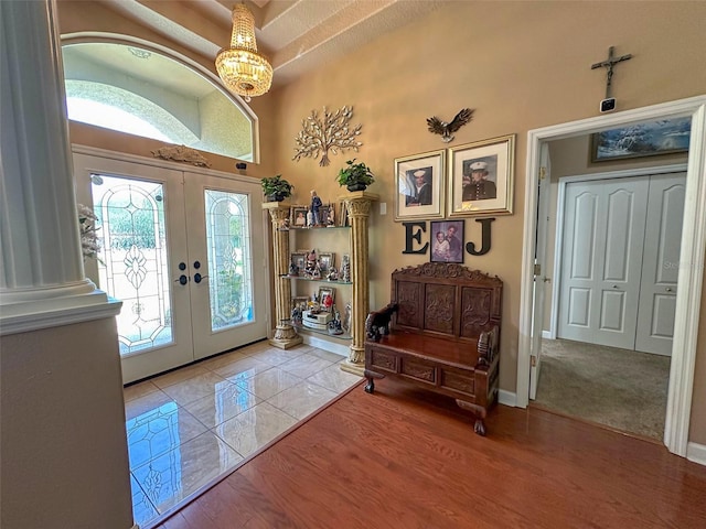 13807 Eagles Rock Ct, Hudson, FL 34667 - entrance foyer with french doors, a chandelier, and wood finished floors