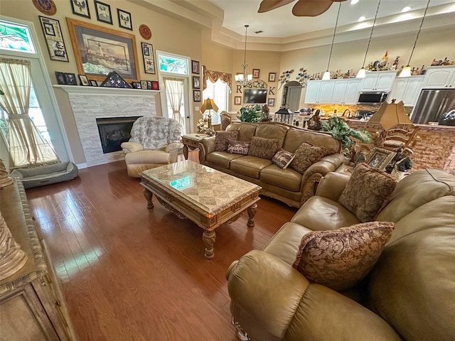 13807 Eagles Rock Ct, Hudson, FL 34667 - living room with healthy amount of natural light, a fireplace, dark wood-type flooring, a ceiling fan, and recessed lighting