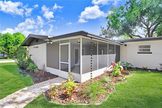 223 Pinehurst Dr, Auburndale, FL 33823 - view of property exterior with a sunroom and a lawn