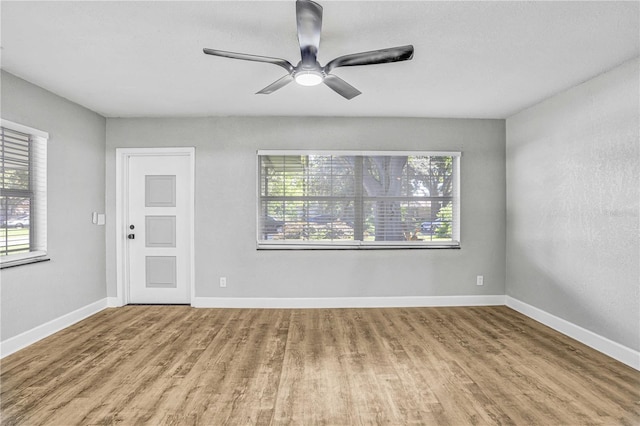 223 Pinehurst Dr, Auburndale, FL 33823 - spare room with healthy amount of natural light, wood finished floors, and ceiling fan