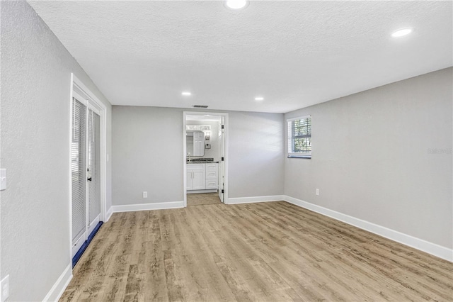 223 Pinehurst Dr, Auburndale, FL 33823 - spare room with light wood-style flooring, recessed lighting, and a textured ceiling