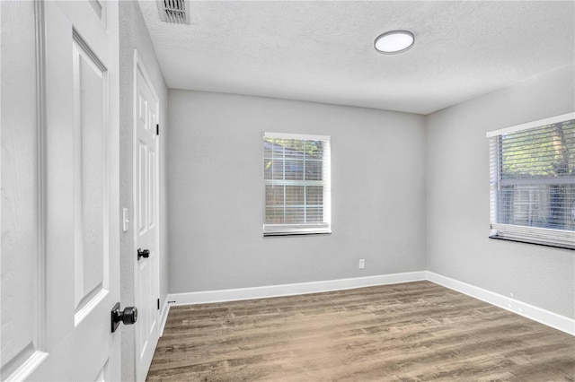 223 Pinehurst Dr, Auburndale, FL 33823 - spare room with a textured ceiling and wood finished floors
