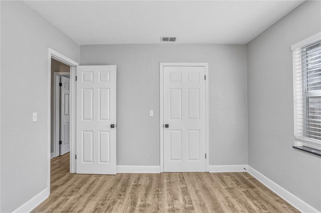 223 Pinehurst Dr, Auburndale, FL 33823 - unfurnished bedroom with wood finished floors and baseboards