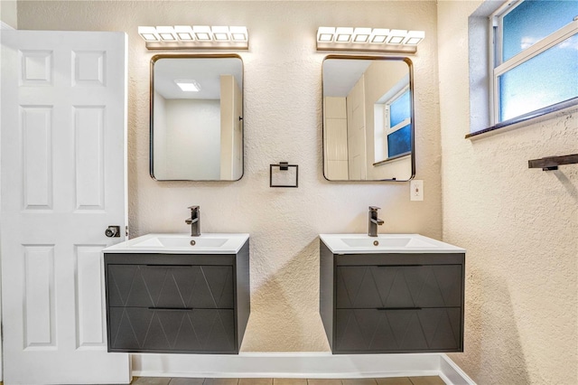 223 Pinehurst Dr, Auburndale, FL 33823 - bathroom featuring two vanities and a textured wall
