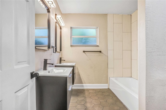 223 Pinehurst Dr, Auburndale, FL 33823 - full bathroom featuring double vanity, a textured wall, tile patterned floors, and tub / shower combination