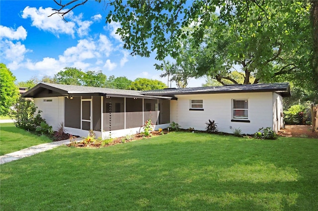 223 Pinehurst Dr, Auburndale, FL 33823 - rear view of property with a sunroom and a lawn